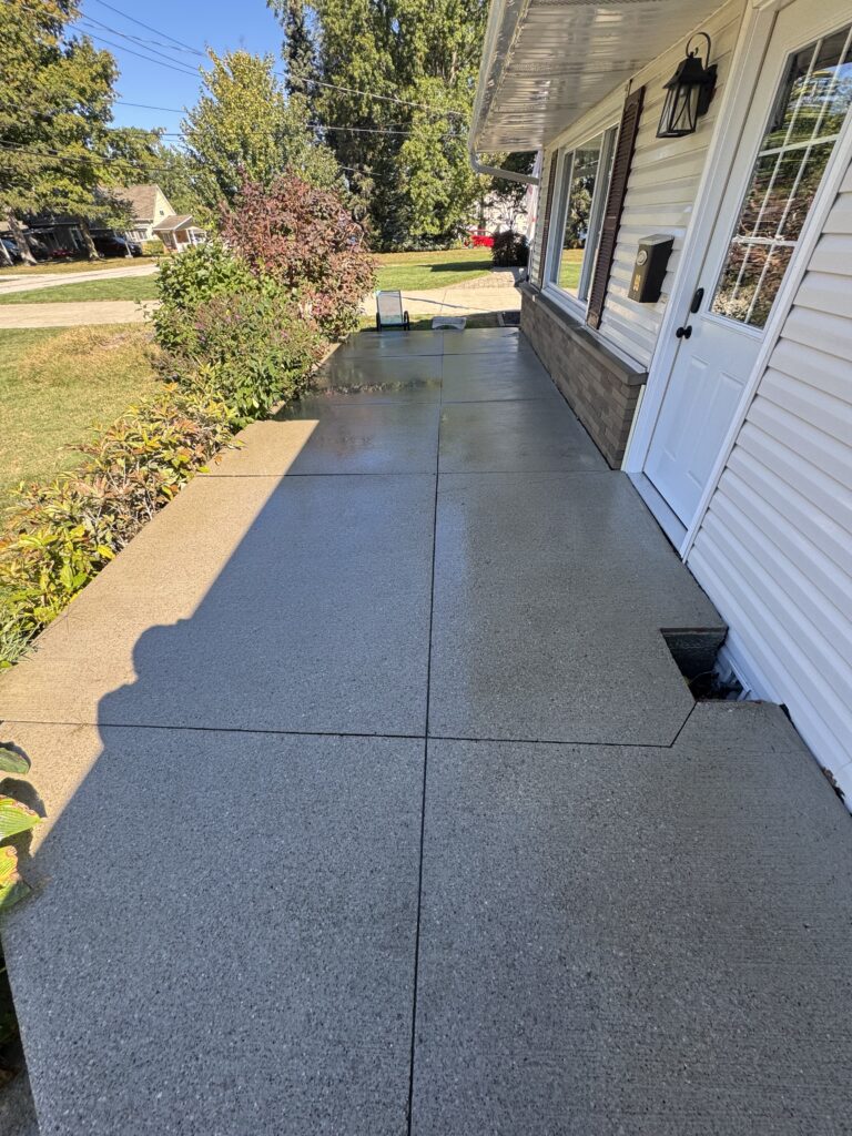 Refreshed driveway after concrete cleaning by Wiley's Pressure Washing Service in Mentor-On-The-Lake OH.