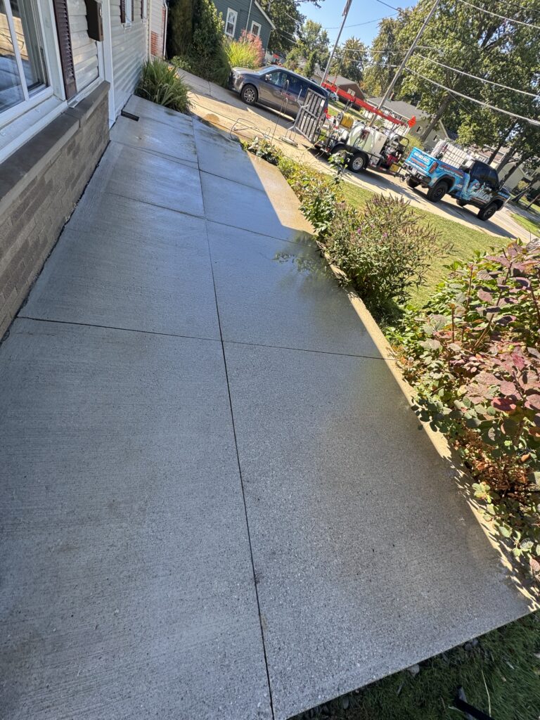 Refreshed driveway after concrete cleaning by Wiley's Pressure Washing Service in Mentor-On-The-Lake OH.