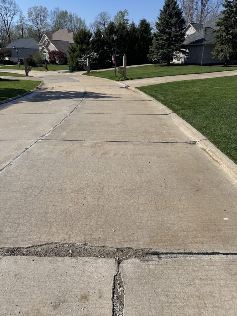 Concrete Cleaning Roadway before and after - by Wiley's pressure washing in Painesville, OH