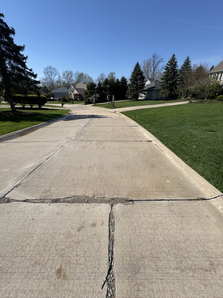 Concrete Cleaning Roadway before and after - by Wiley's pressure washing in Painesville, OH