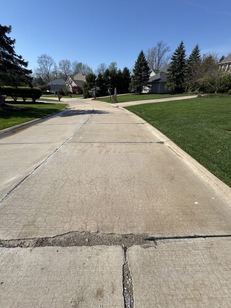 Concrete Cleaning Roadway before and after - by Wiley's pressure washing in Painesville, OH