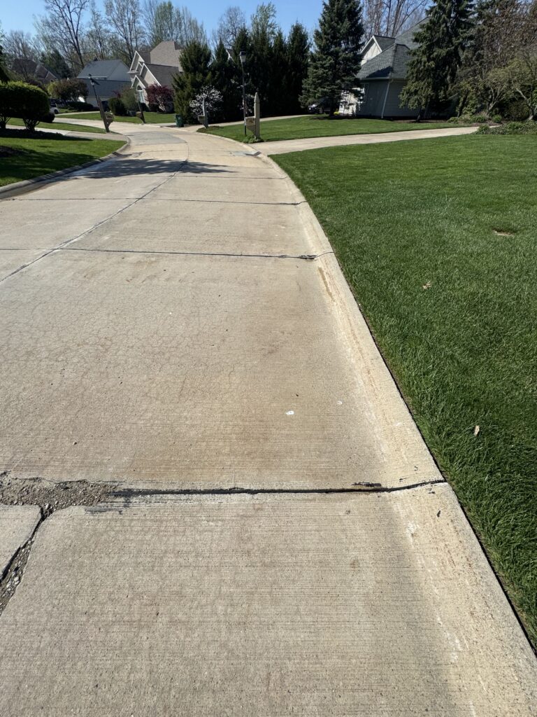 Concrete Cleaning Roadway before and after - by Wiley's pressure washing in Painesville, OH