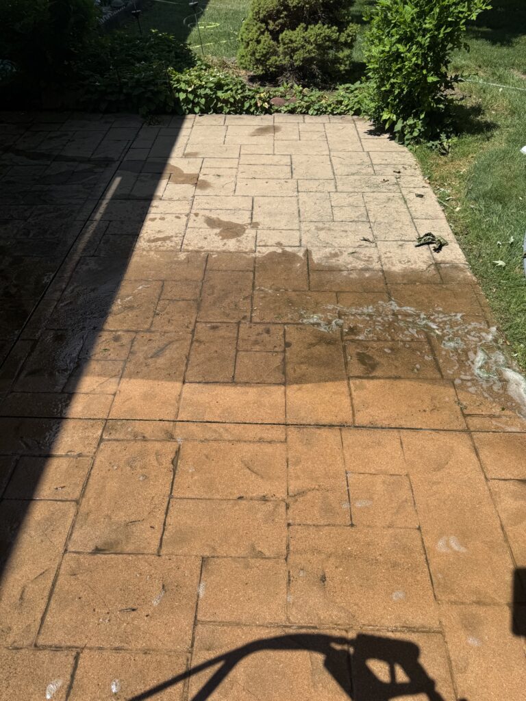 Patio with wet tan bricks Before and After cleaning in Madison, OH from Wiley's Pressure Washing Services