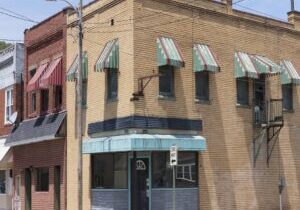 Storefront on main street,united states,apartment buildings and storefronts along an empty street.
